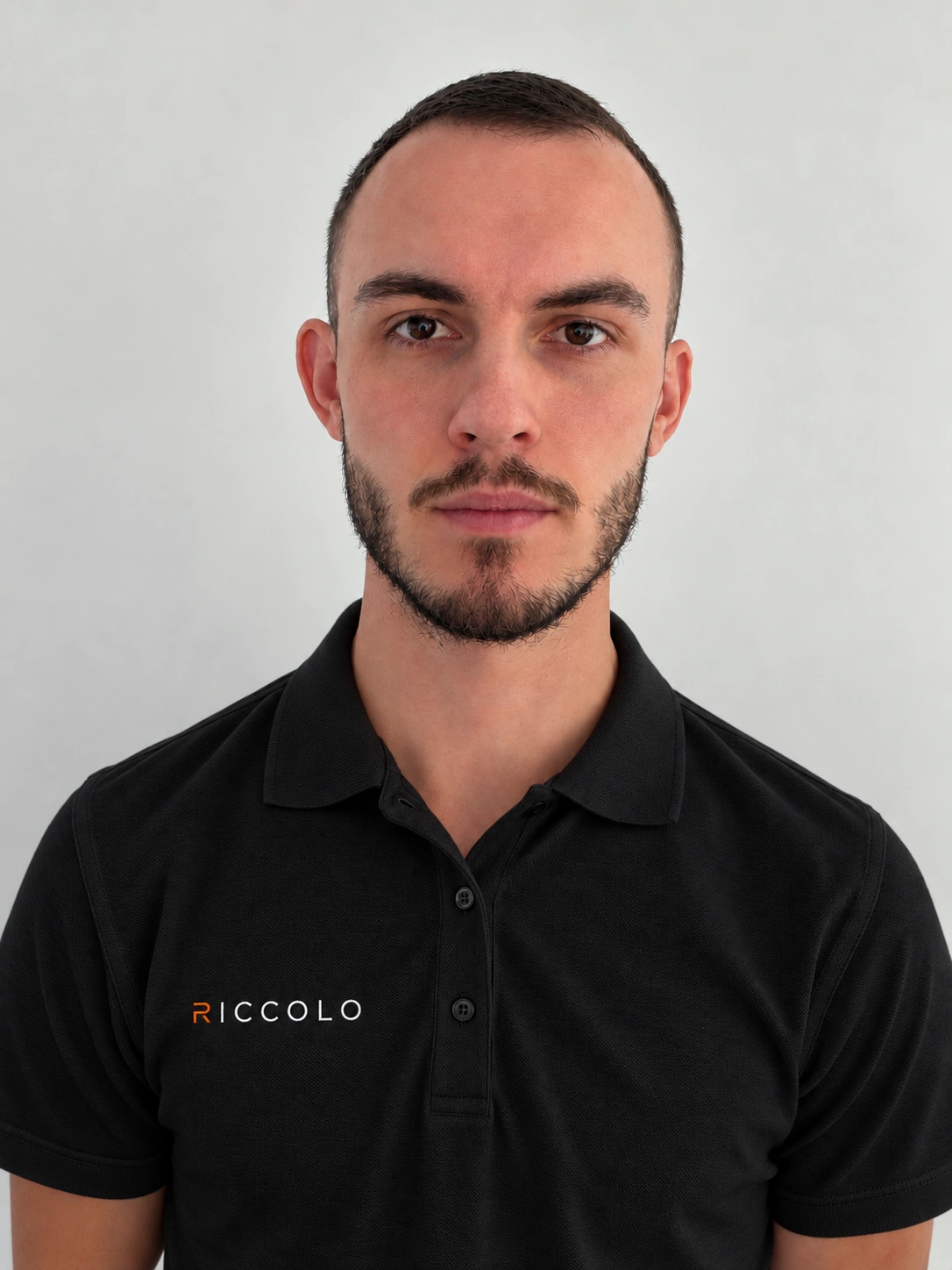 Richard Pett, founder of Riccolo, wearing a black polo with the orange Riccolo wordmark